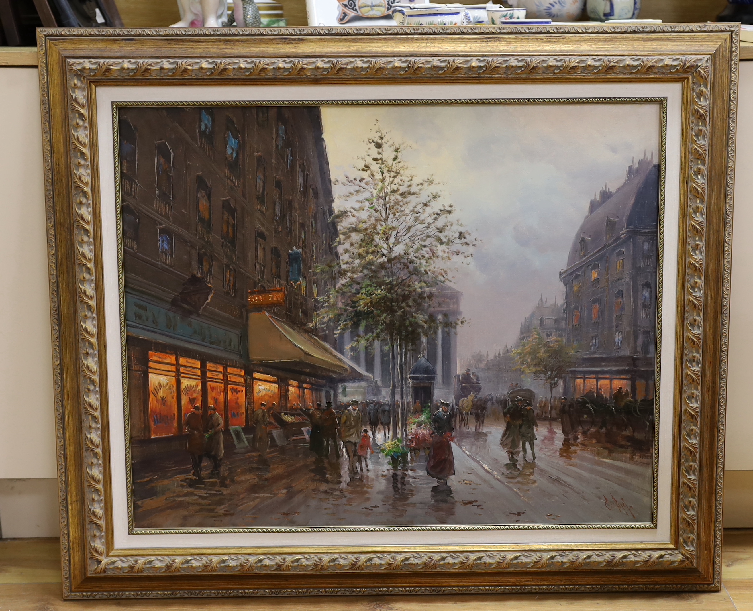 A decorative oil on canvas, street scene with figures, indistinctly signed, 64 x 80cm, gilt frame